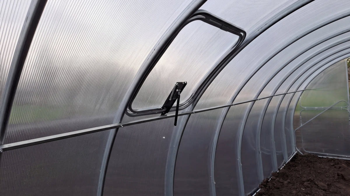 Inside a SteelRoot Plot 3.14, looking down the row of galvanised steel arches