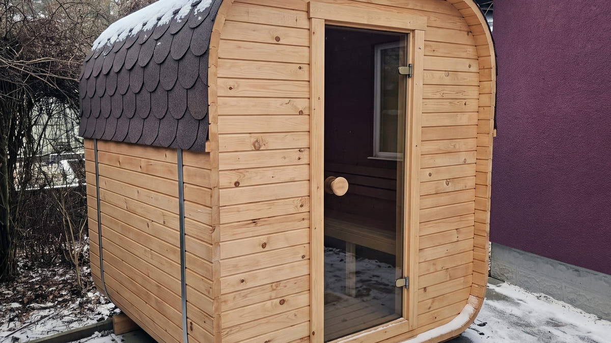 The Cabin Three electric outdoor sauna with a bitumen shingle roof