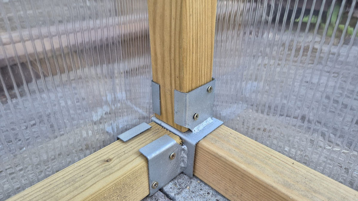 NORDIC corner post held by a galvanised foot bracket on a brick base