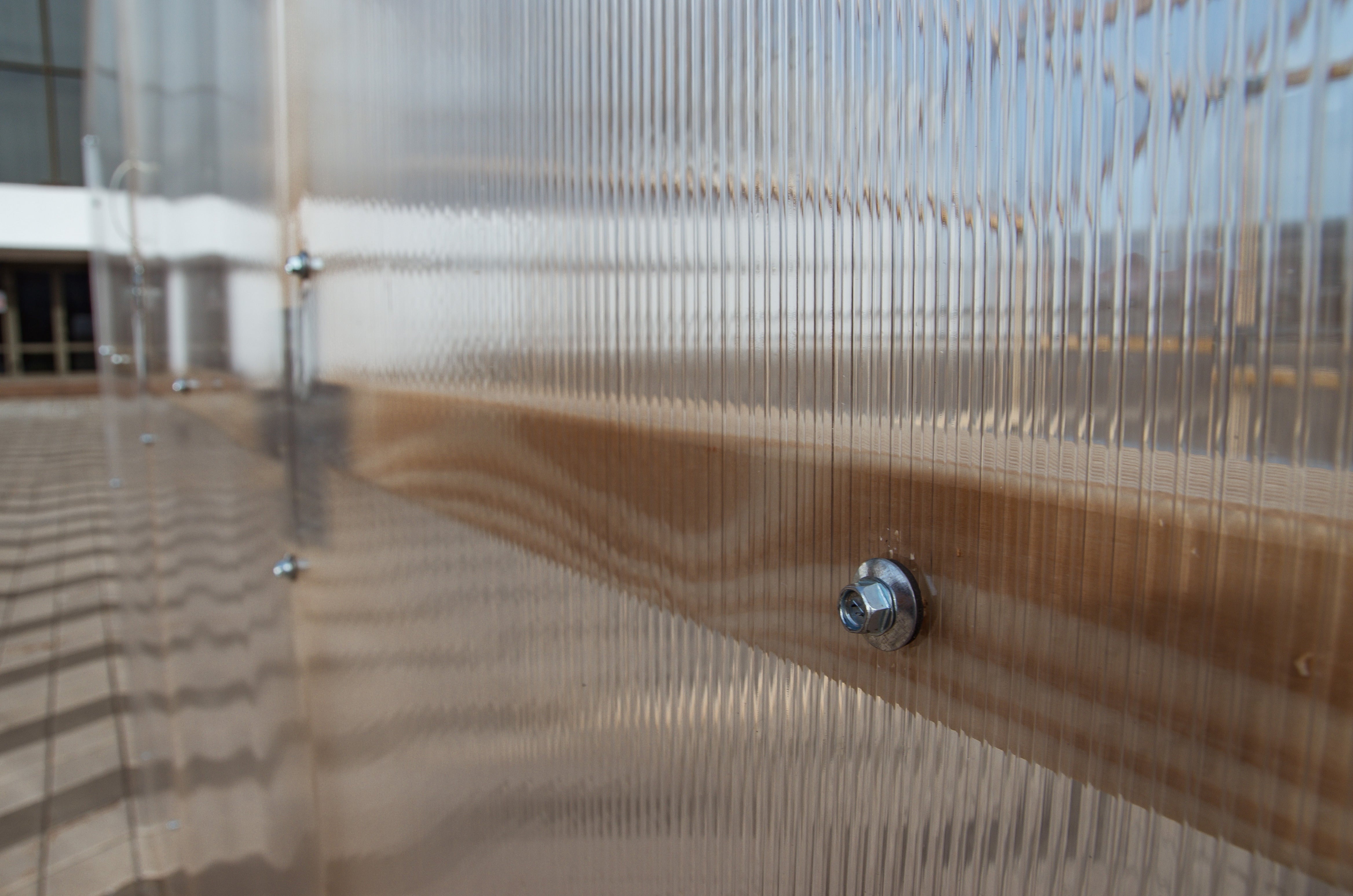 Twin-wall polycarbonate panel screw-fixed to the pine frame of a NORDIC greenhouse