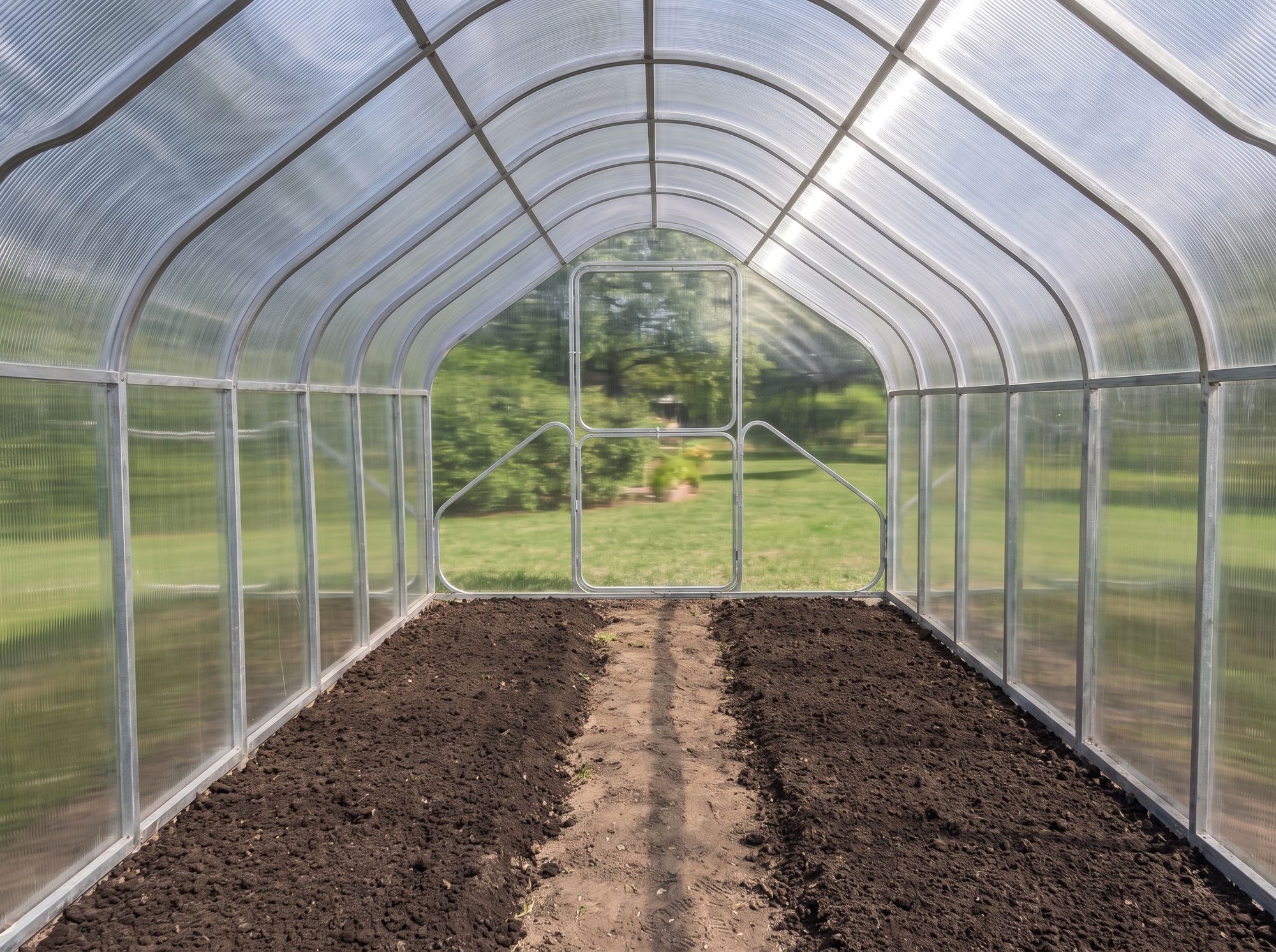 Raised beds inside a steel greenhouse