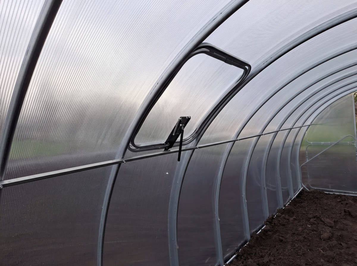 Inside a SteelRoot Plot 3.14, looking down the row of galvanised steel arches