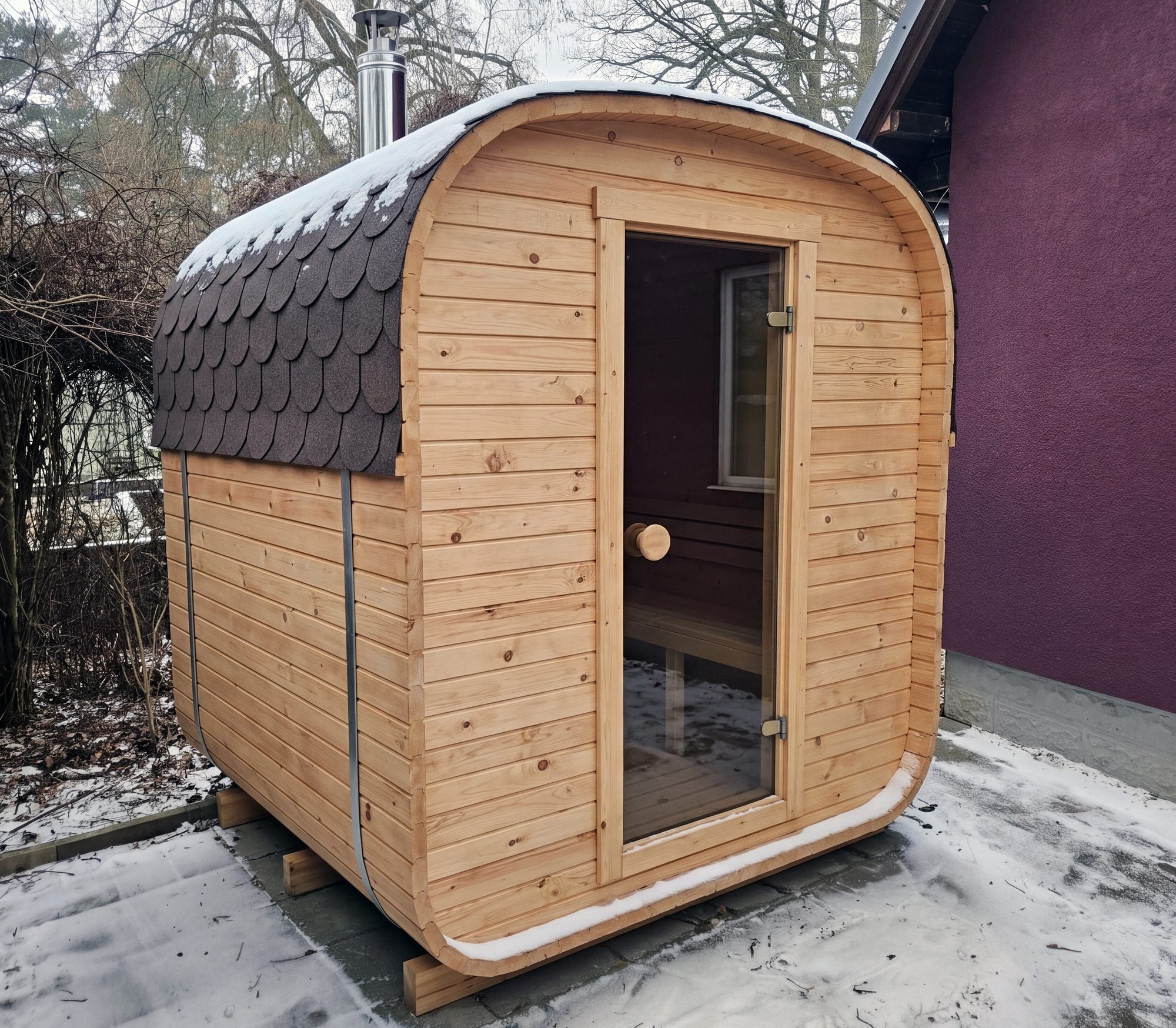 The Cabin Three electric outdoor sauna with a bitumen shingle roof