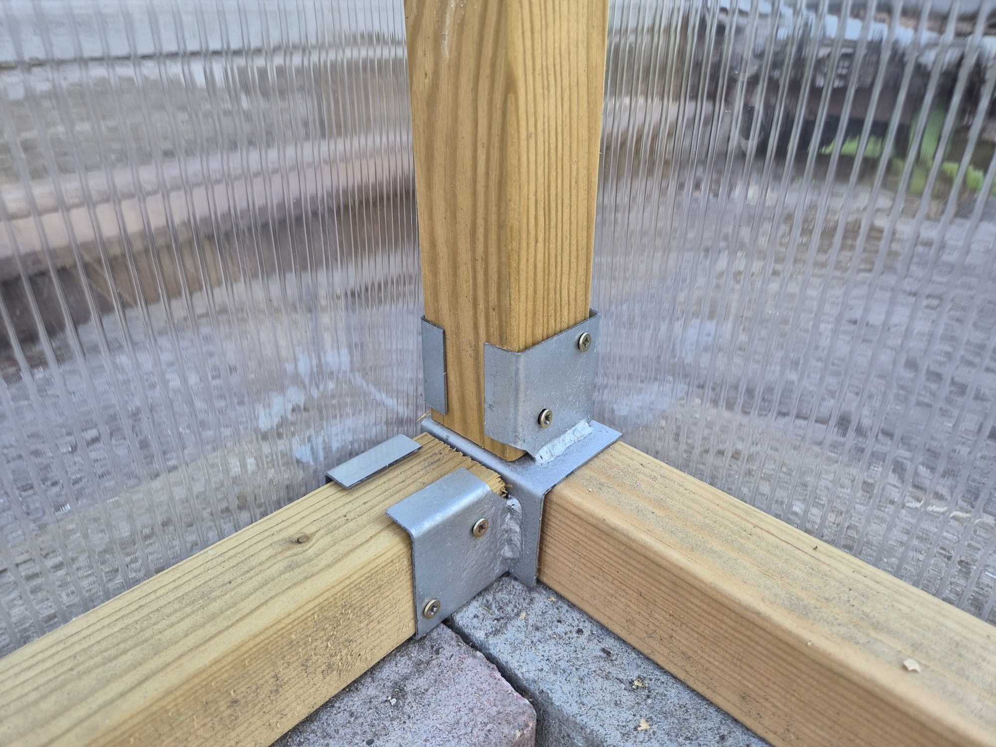 NORDIC corner post held by a galvanised foot bracket on a brick base