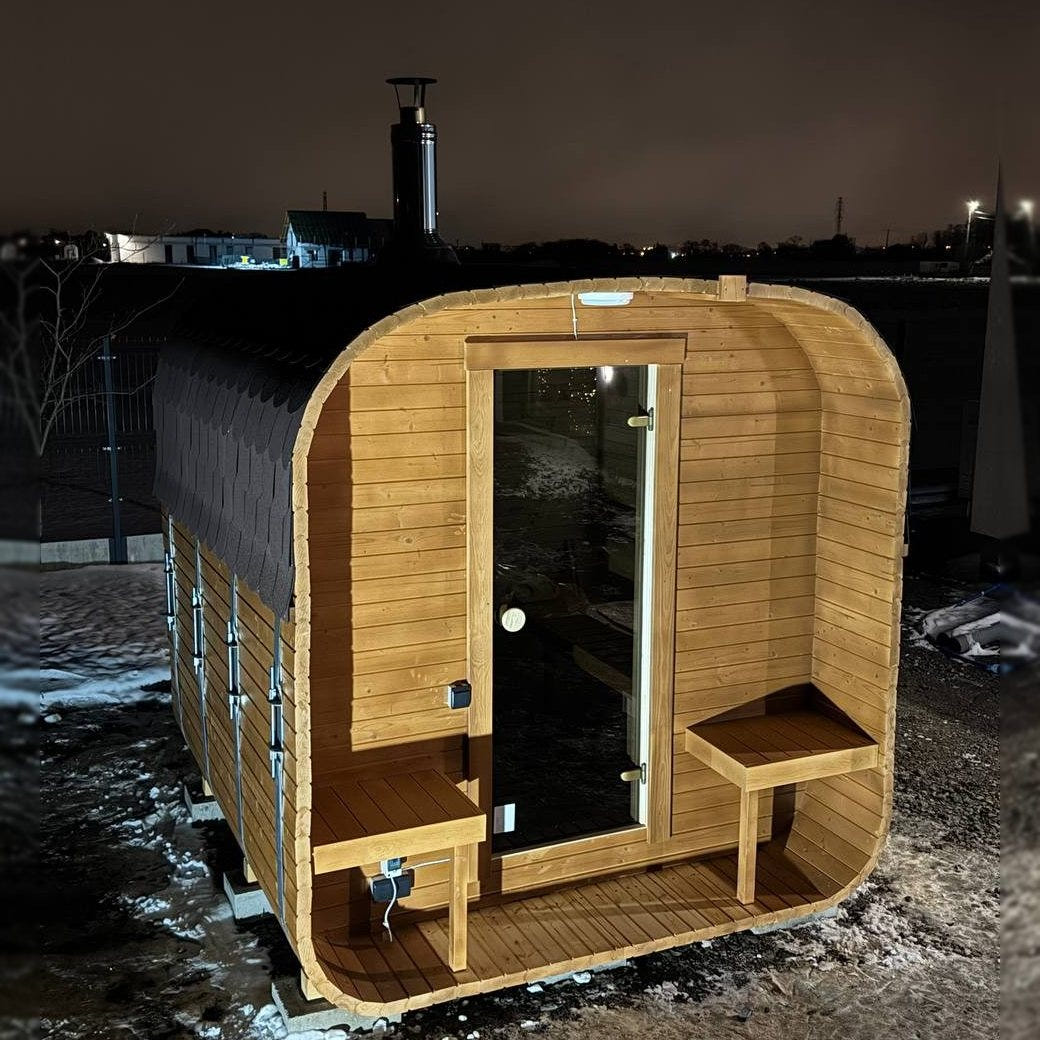 The Cabin Four wood-fired sauna in a honey finish, three-quarter view at dusk