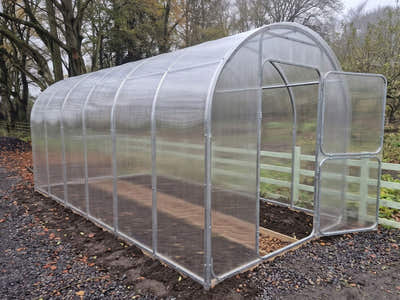 SteelRoot Climber 2.10 greenhouse, 6 m long, with the door open, in an autumn garden