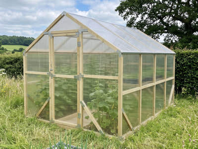 NORDIC wooden greenhouse, 2.6 m wide, in a meadow garden