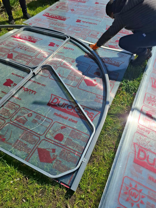 End arch frame laid on a polycarbonate sheet as a cutting template