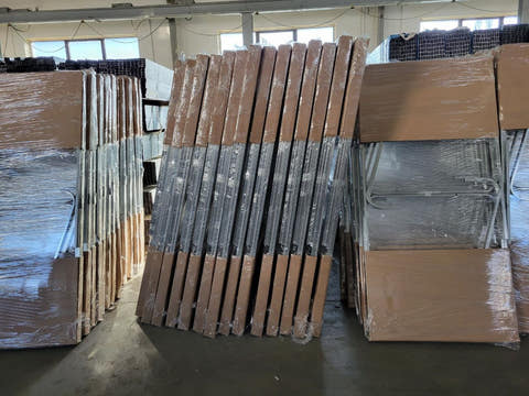 Frame parts wrapped in card and film, ready for the pallet