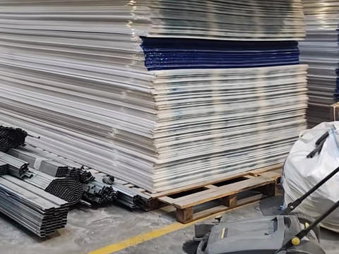 Stacks of polycarbonate sheets on pallets