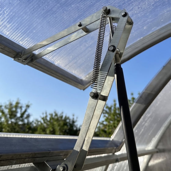 A roof vent held open by its automatic opener